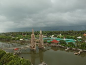 View of bridge over river against cloudy sky