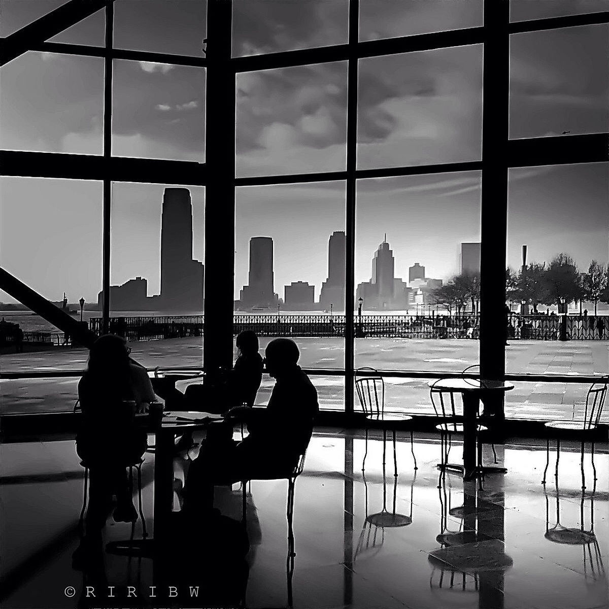 architecture, water, built structure, nautical vessel, indoors, city, men, reflection, transportation, sky, window, glass - material, boat, sitting, mode of transport, building exterior, table, river, travel