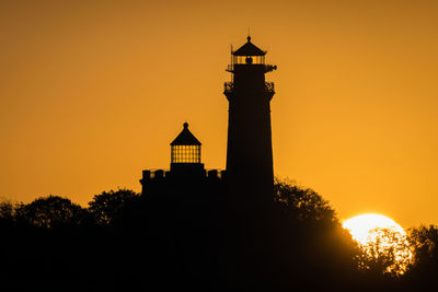 Silhouette of building against sky during sunset