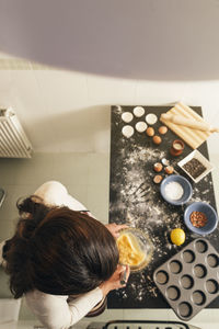 High angle view of woman preparing food on table at home