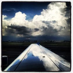 Scenic view of landscape against cloudy sky