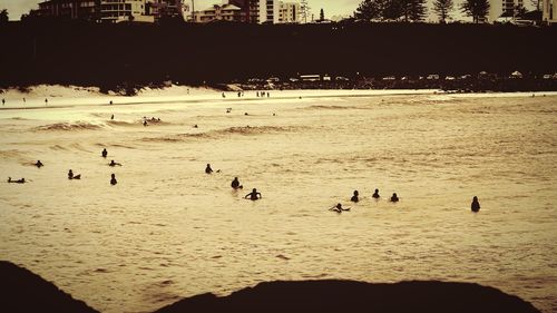 High angle view of silhouette people on calm beach