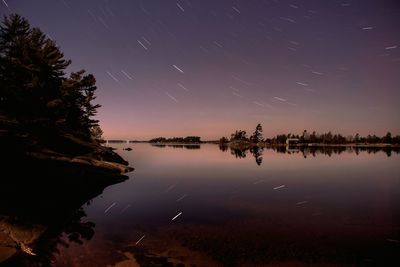 Reflection of trees in water at night