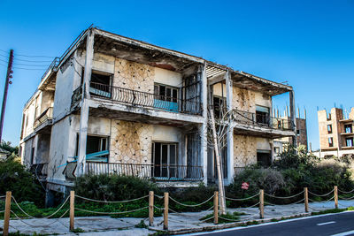 Low angle view of old building against clear blue sky