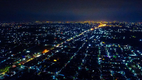 Aerial view of illuminated city at night