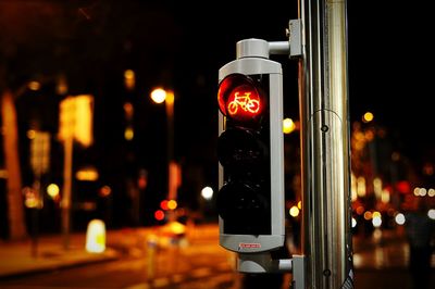 Close-up of road signal at night