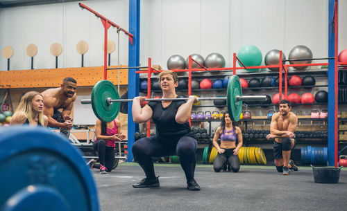 Side view of woman exercising in gym