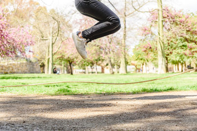 Low section of man jumping in park