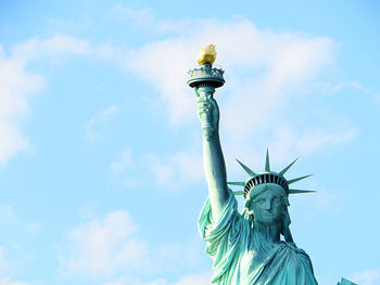 Low angle view of statue of liberty against sky