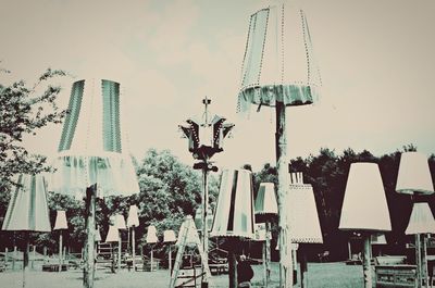 Low angle view of lighting equipment on table against sky