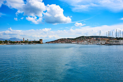 Scenic view of sea by city against sky