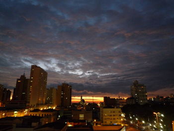 Illuminated buildings against sky at night