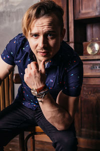 Portrait of young man sitting outdoors