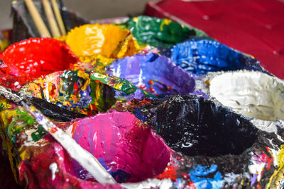 Close-up of messy paint cans in workshop