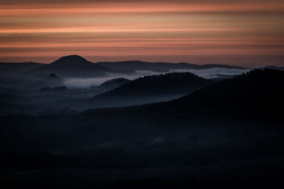 Scenic view of silhouette mountains against sky during sunset