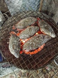 High angle view of meat on barbecue grill