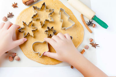 High angle view of hand holding cookies on table