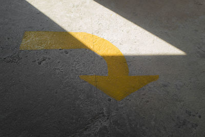 High angle view of arrow sign on road