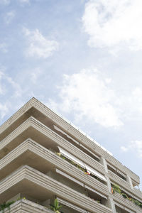 Low angle view of building against cloudy sky