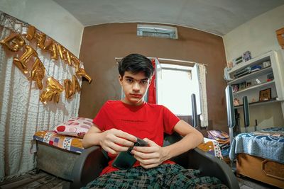 Portrait of young man sitting at home