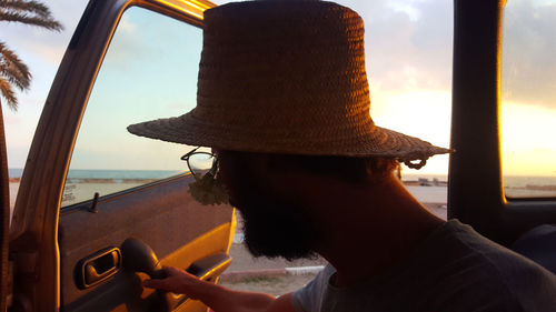 Portrait of man in hat against sea