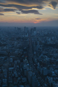 High angle view of buildings in city during sunset