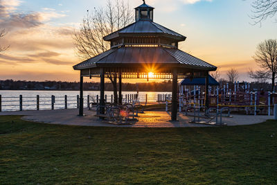 Gazebo by sea against sky during sunset