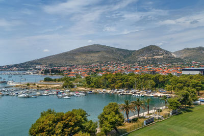 Scenic view of lake by city against sky