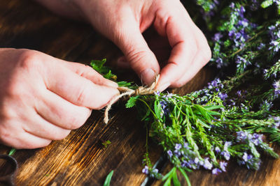 Close-up of hand holding food on table