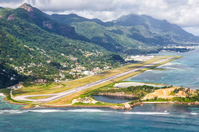 Scenic view of sea and mountains against sky