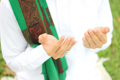 Midsection of woman praying