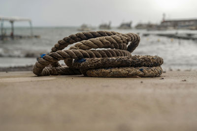Close-up of rope tied on pier