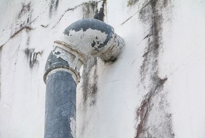 Low angle view of pipe on wall