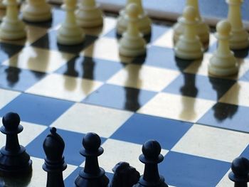 Close-up of a chess board on tiled floor