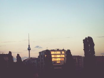 Communications tower against sky at sunset