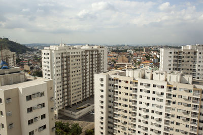 High angle view of buildings in city against sky