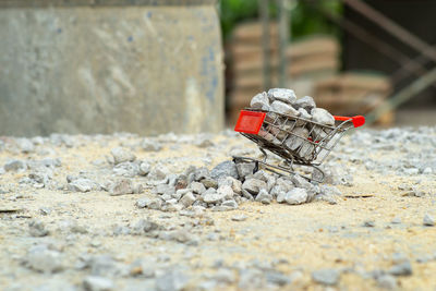 Selective focus on shopping trolley carries the crushed stones and pouring onto the pile at the site