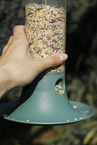 Woman's holding bird seed feeder.
garden wild bird feeder