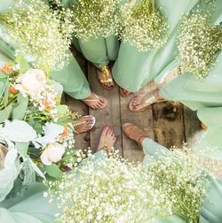 Low section of people by flowering plants