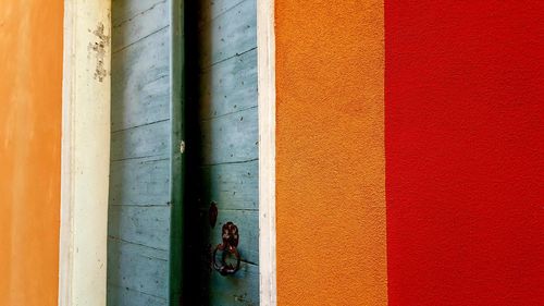 Close-up of metal gate against wall