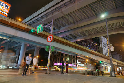 People at illuminated city at night