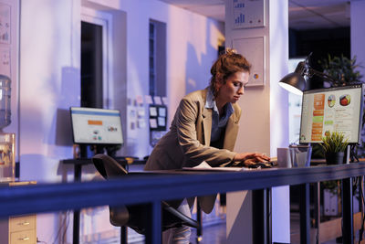 Businesswoman using laptop at office