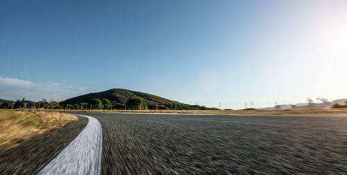 Surface level of road against clear sky