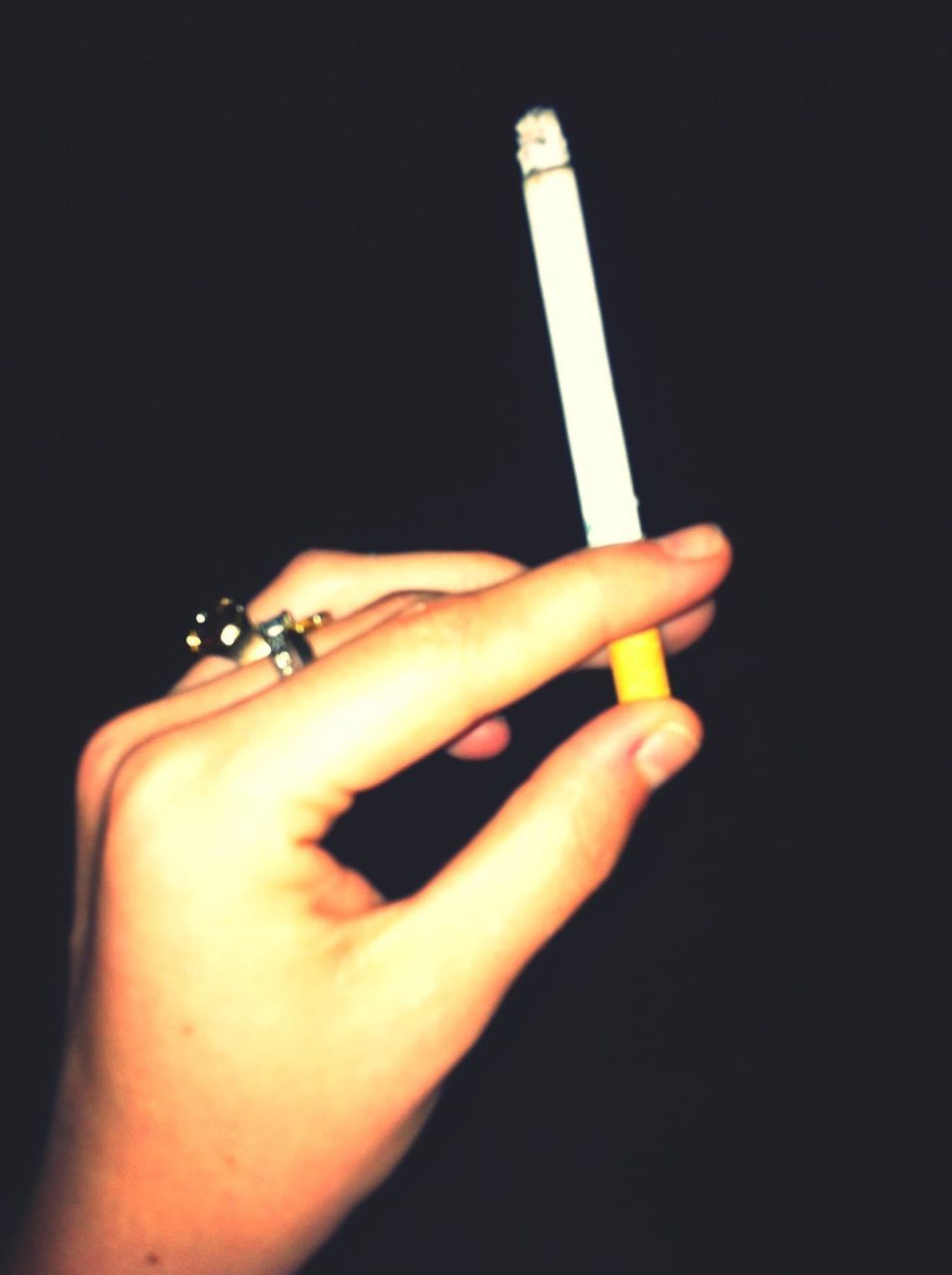 person, part of, holding, human finger, studio shot, cropped, black background, close-up, lifestyles, indoors, copy space, night, leisure activity, dark, unrecognizable person, cigarette