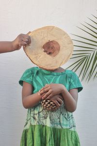 Midsection of woman with hat on table
