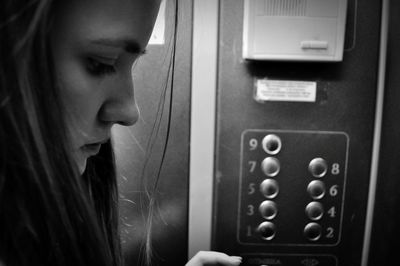 Close-up of young woman in elevator