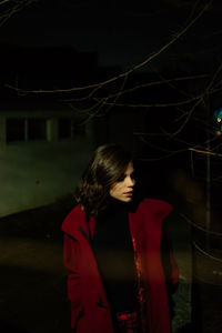 Young woman looking away at night