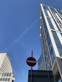 Low angle view of modern buildings against blue sky