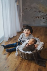 Portrait of boy and new born baby