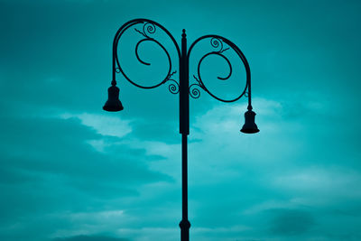 Low angle view of street light against blue sky